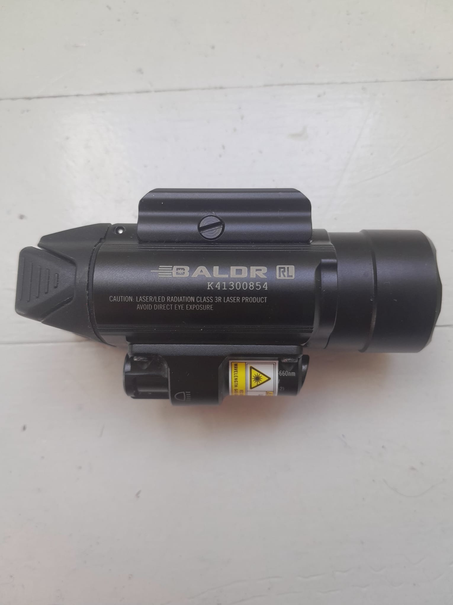 Olight Baldr RL – Lampe Tactique 1120 Lumens + Laser Rouge (État Nickel)